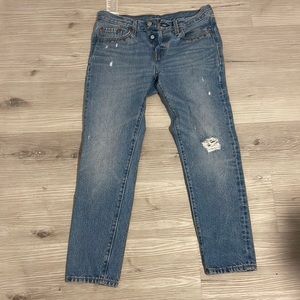501 Levi’s with ripped knee